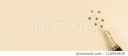 Champagne bottle with confetti snowflakes. New Year, Christmas, celebration concept. Flat lay. Banner. Copy space 118004648