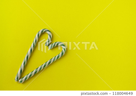 heart shaped green candy canes on gray background 118004649