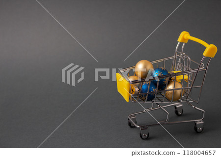 Christmas balls in mini shopping trolley for Christmas and New Year festival concept. High quality photo 118004657
