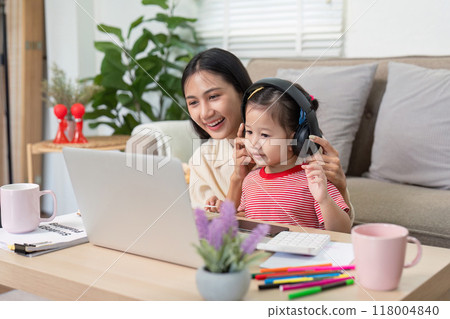 Mother and daughter enjoying music together on laptop Mother and daughter enjoying music together on laptop 118004840