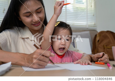 Joyful mother and daughter drawing session at home 118004846