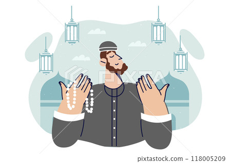 Islamic man praying doing hajj in holy month of ramadan or eid al-fitr, stands near mosques 118005209