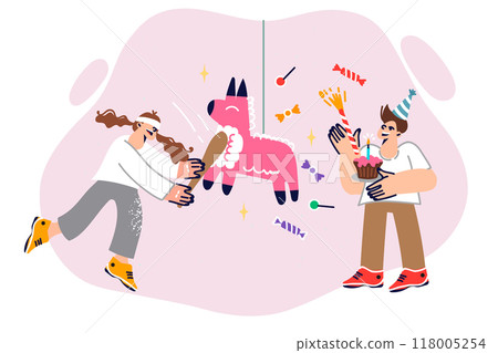 Girl hits pinata with baton during birthday party to get sweets inside hanging pony. 118005254