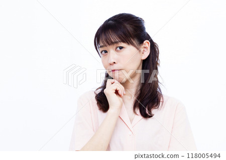 A woman who is seriously worried 118005494