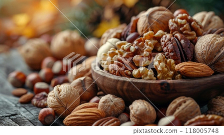 Thanksgiving and Harvest Festival. A close-up shot of a variety of nuts, including walnuts, pecans, and hazelnuts, their textures and colors reflecting the richness of the harvest season. Thanksgiving and Harvest Festival. A close-up shot of a variety of nuts, including walnuts, pecans, and hazelnuts, their textures and colors reflecting the richness of the harvest season. 118005748