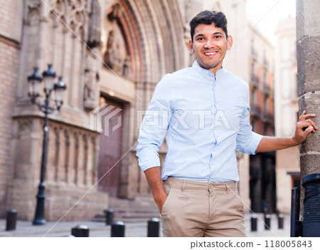 Smiling young guy on city street Smiling young guy on city street 118005843