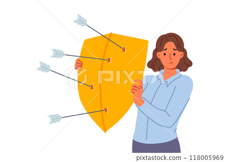 Upset woman defends from arrows of enemies, covering with shield to avoid injury 118005969