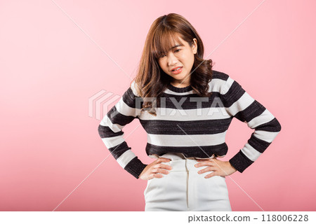 Portrait of Asian beautiful young woman has stomachache, female abdominal pain suffering from stomach ache, studio shot isolated on pink background, period pain, Health and medical gastritis concept Portrait of Asian beautiful young woman has stomachache, female abdominal pain suffering from stomach ache, studio shot isolated on pink background, period pain, Health and medical gastritis concept 118006228