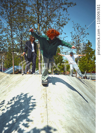 Dynamic image of young people in stylish clothes, in motion, skateboarding, training in public park on sunny warm day. Dynamic image of young people in stylish clothes, in motion, skateboarding, training in public park on sunny warm day. 118006381