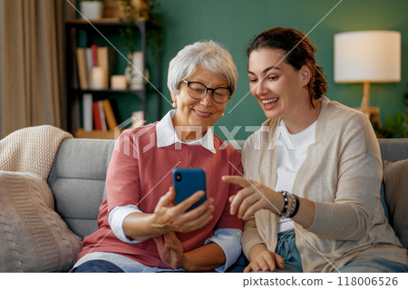 Young and senior women are using smartphone Young and senior women are using smartphone 118006526