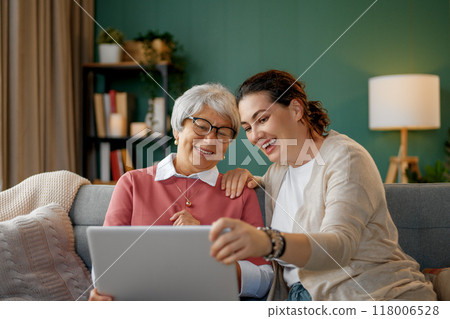 Young and senior women are using laptop Young and senior women are using laptop 118006528