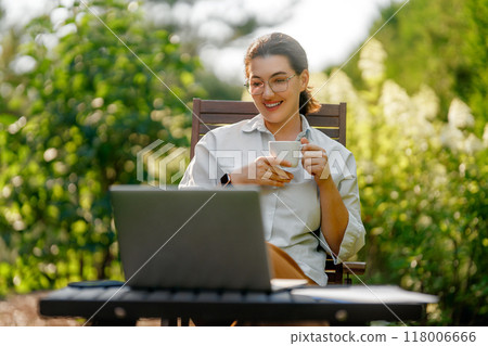 woman working on laptop in summer morning woman working on laptop in summer morning 118006666