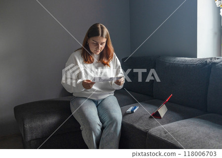 Caucasian woman holds nasal swab and puts into nose for COVID-19 self test at home Caucasian woman holds nasal swab and puts into nose for COVID-19 self test at home 118006703