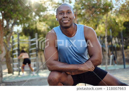 African athletic man do leg stretching exercises outdoors 118007663