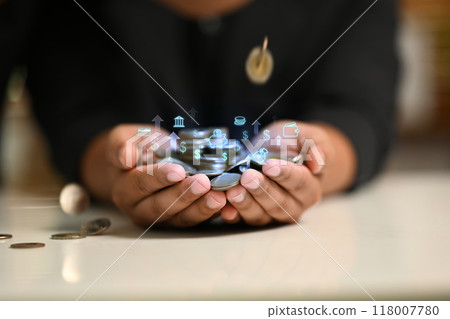 Close up of hands holding a pile of coins. Investment, financial management and prosperity concept Close up of hands holding a pile of coins. Investment, financial management and prosperity concept 118007780