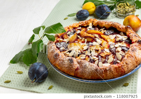 Open pie (galette) with plums and cardamom. Open pie (galette) with plums and cardamom. 118007925