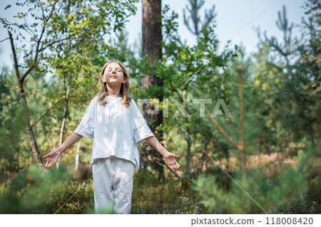 A teenage girl who breathes fresh air and relieves stress in the forest. 118008420