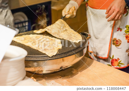 Freshly baked Turkish Gozleme, flatbread with greens and cheese. Freshly baked Turkish Gozleme, flatbread with greens and cheese. 118008447