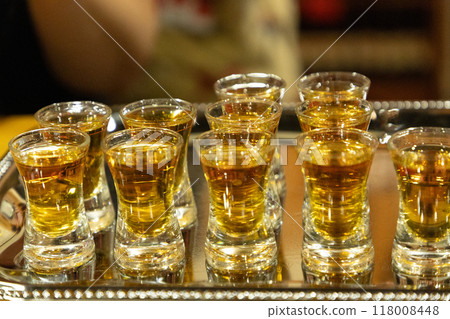 Strong alcoholic drink in small glasses. Strong alcoholic drink in small glasses. 118008448
