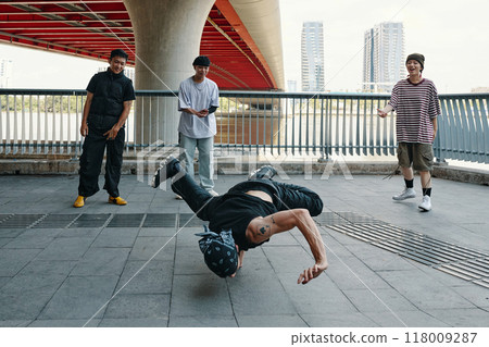 Practicing Breakdancing Moves Under Urban Bridge 118009287