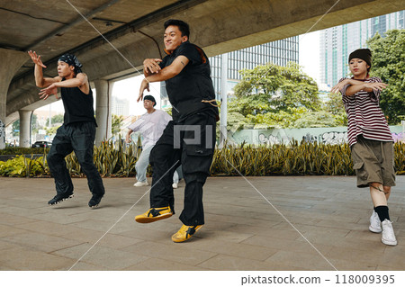 Urban Street Dancers Performing under Bridge Together Urban Street Dancers Performing under Bridge Together 118009395