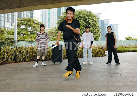Dancing Outdoors with Friends in Urban Park Setting Dancing Outdoors with Friends in Urban Park Setting 118009401
