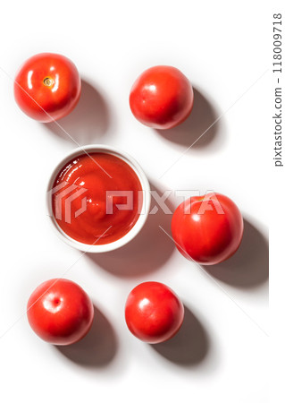 Ripe tomatoes and bowl of ketchup on white background, top view 118009718