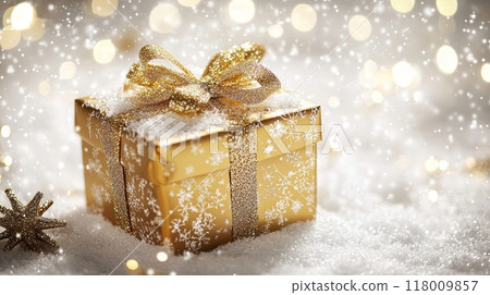 golden gift box with a glittering bow, surrounded by snow and shimmering lights 118009857