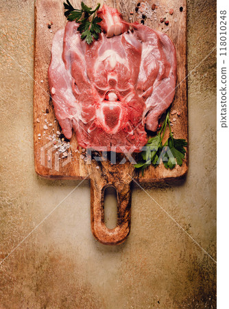raw steak, veal neck on the bone, fresh meat, on a cutting board, with spices, top view, without people, 118010248
