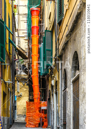 Orange temporary prefabricated plastic construction debris pipe at building repair construction site 118010641