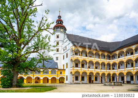 Charming Velke Losiny Chateau courtyard, admiring the elegant architecture and lush greenery on a bright day in Czechia. The historic site showcases its rich cultural heritage. 118010822