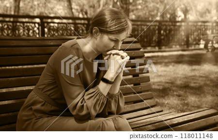 Pretty girl sitting on the bench Pretty girl sitting on the bench 118011148