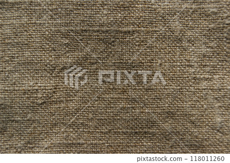 Natural linen fabric. Beige linen background, fabric texture for fashion design or upholstered furniture Natural linen fabric. Beige linen background, fabric texture for fashion design or upholstered furniture 118011260