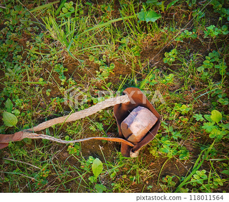 An antique leather sling lies on the ground An antique leather sling lies on the ground 118011564