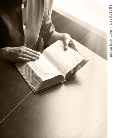 Woman's hands holding a bible Woman's hands holding a bible 118011591