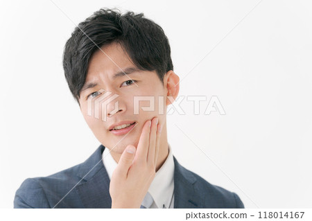 Young man with hands on face 118014167