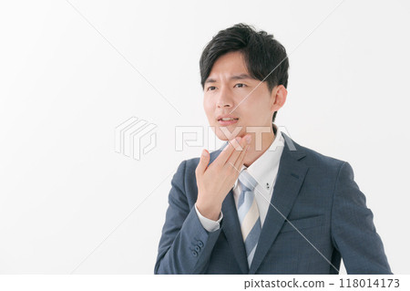 Young man with hands on face 118014173