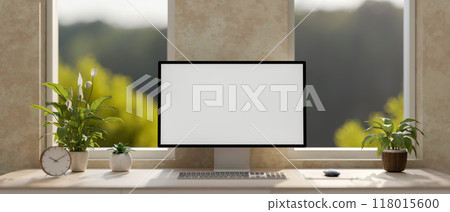 A modern loft office workspace features a computer with a white screen mockup on a table. 118015600