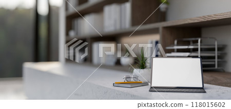 A digital tablet with a white screen mockup and a wireless keyboard in a contemporary room. 118015602