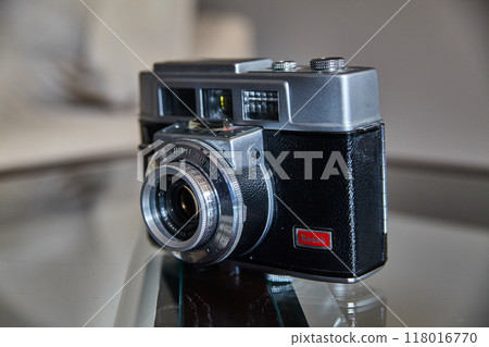 Vintage Film Camera on Reflective Surface with Soft Lighting 118016770