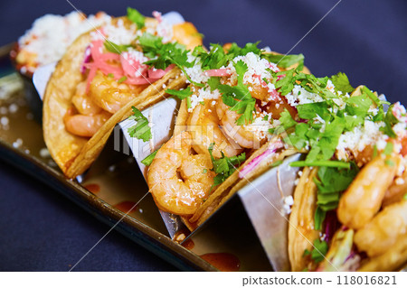 Gourmet Shrimp Taco with Fresh Garnishes, Overhead View 118016821