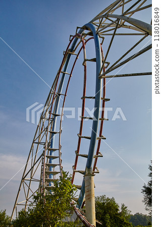 Abandoned White and Red Roller Coaster with Blue Sky Ground Up View 118016849
