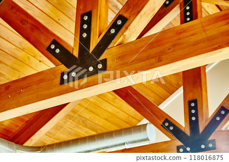 Warm Wooden Ceiling with Black Metal Brackets Detail Warm Wooden Ceiling with Black Metal Brackets Detail 118016875