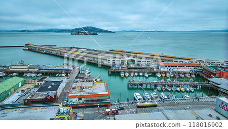 Pier 45 aerial over San Francisco Bay with Alcatraz Prison Island in distance, CA 118016902