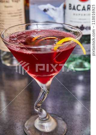 Red Cocktail with Orange Twist in Upscale Bar Setting Red Cocktail with Orange Twist in Upscale Bar Setting 118016925