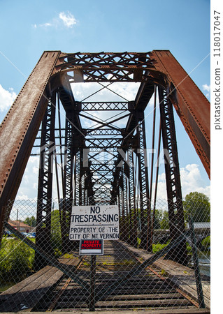 Rusted Steel Truss Bridge with No Trespassing Sign, Ground View 118017047