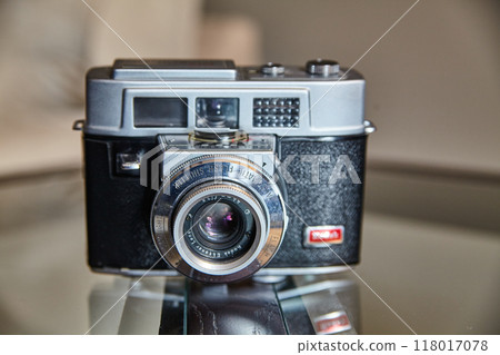 Vintage Film Camera on Reflective Surface, Eye-Level View Vintage Film Camera on Reflective Surface, Eye-Level View 118017078