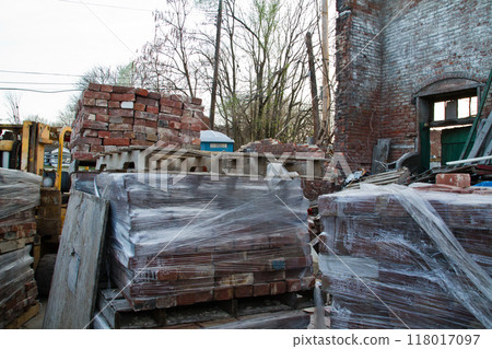 Construction Site Chaos with Bricks on Pallets and Forklift in Open Building Construction Site Chaos with Bricks on Pallets and Forklift in Open Building 118017097