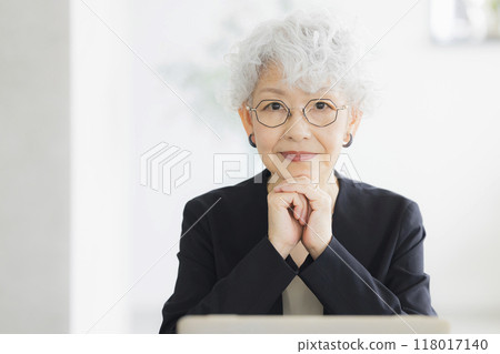 A senior woman operating a computer A senior woman operating a computer 118017140