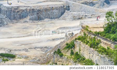 Aerial View of Large Quarry with Excavators and Terraced Rock Walls 118017305